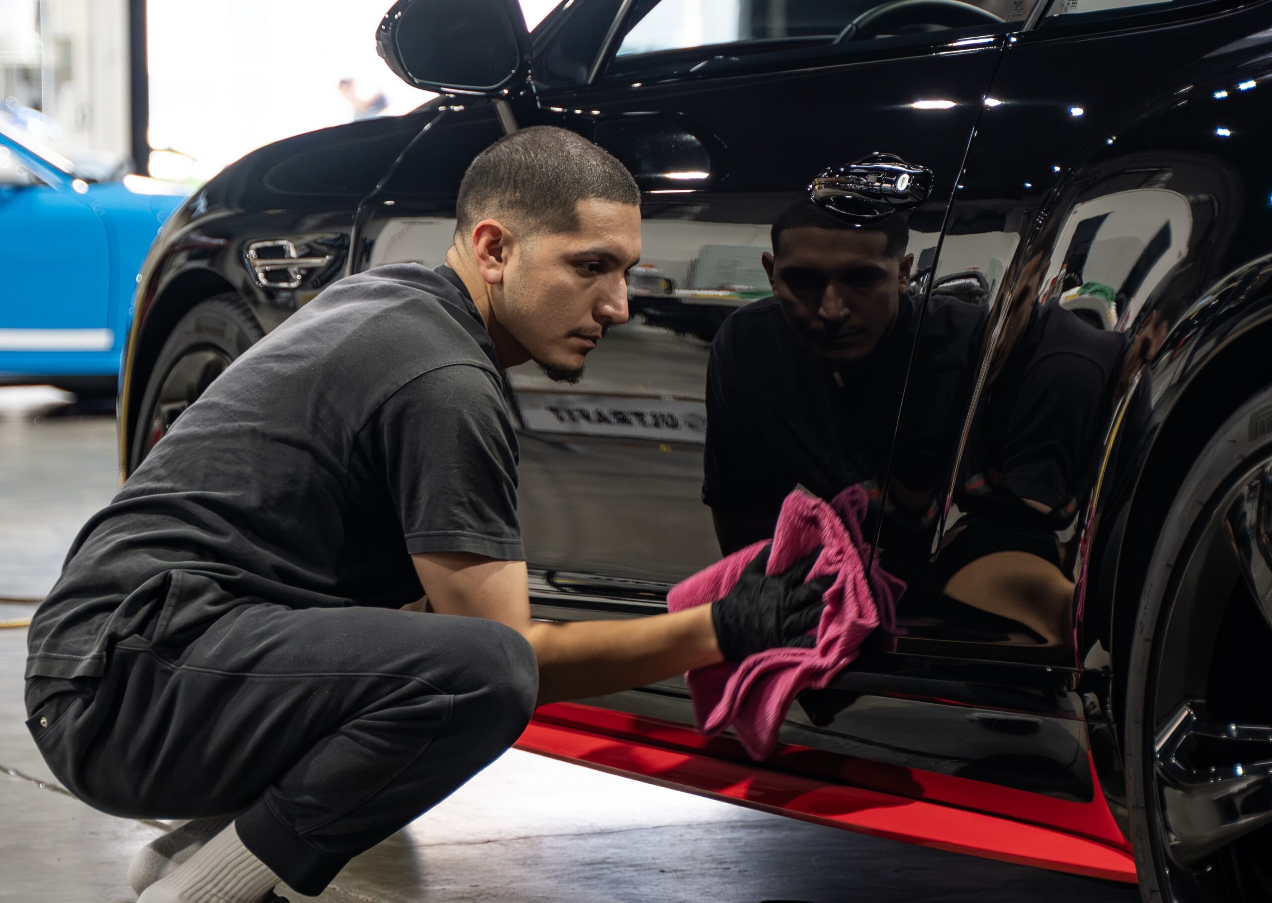 A technician installs Ceramic Coating on a Bently inside the shop at SSS Customs in Menlo Park, California - the Bay Area's Oldest 5-star rated Vehicle Customization Shop